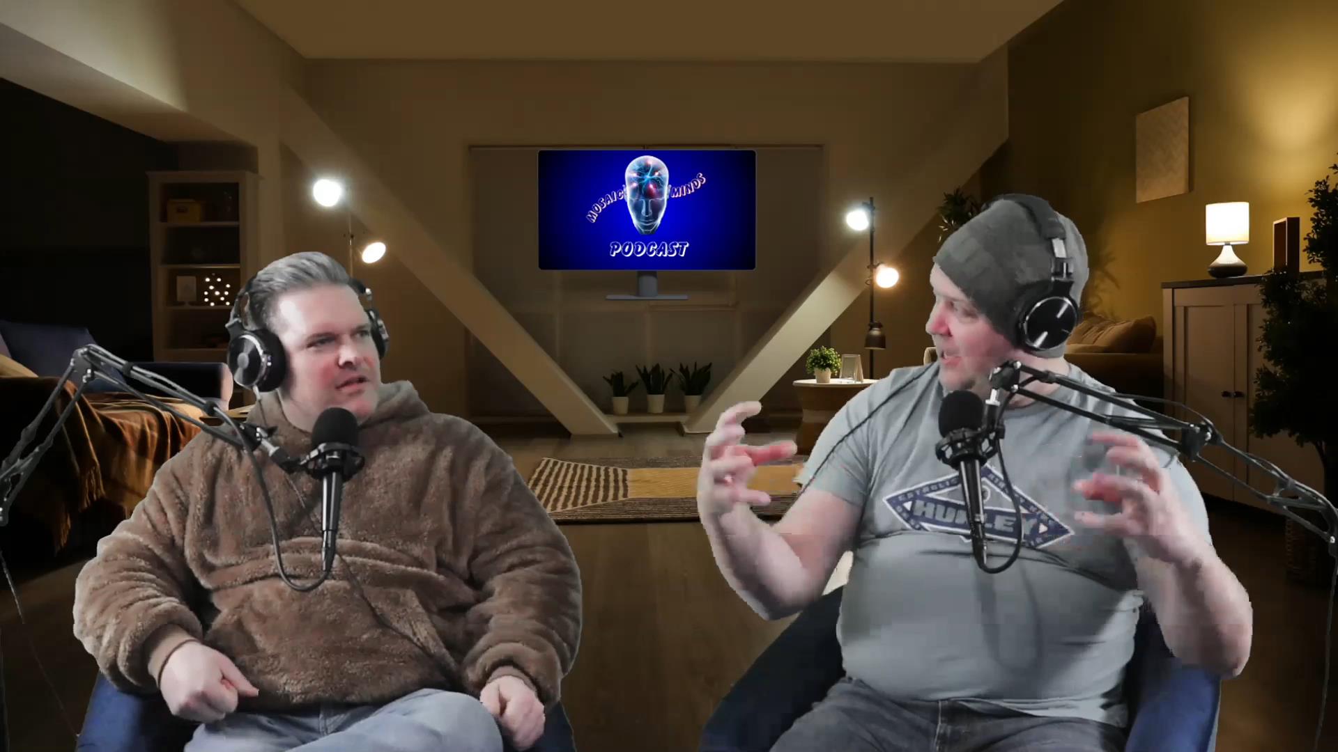 Nick Williams and Jason Yocum in conversation, wearing headphones at their microphones